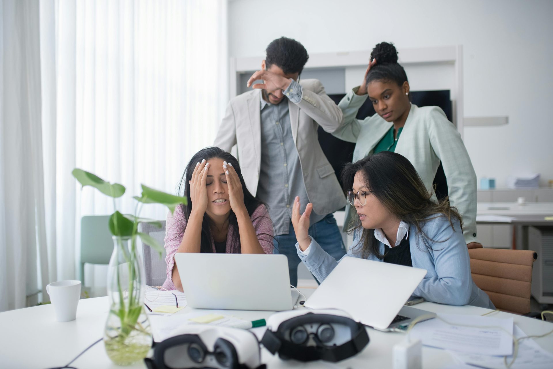 Stressed colleagues looking at a laptop